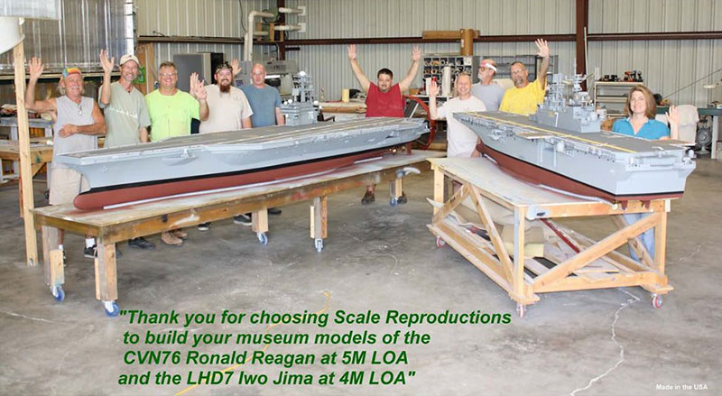 Built to Scale (fka Scale Reproductions) team standing behind two model ships in workshop